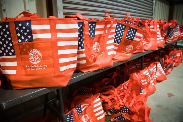 Rows of American flag tote bags set out for guests